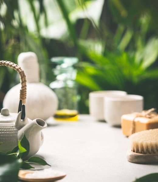 Tea composition on tropical leaves background- healthy life and relaxation concept